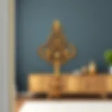 Elegant brass over the door hook with decorative elements.