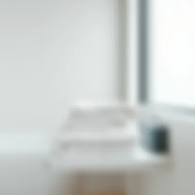 Minimalist bathroom showcasing small lightweight bath towels neatly folded on a shelf.